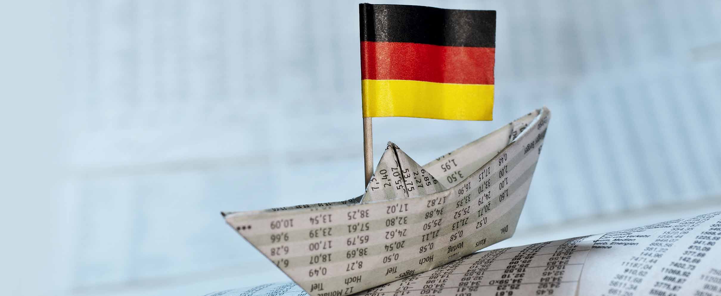 A small paper boat with the German flag.