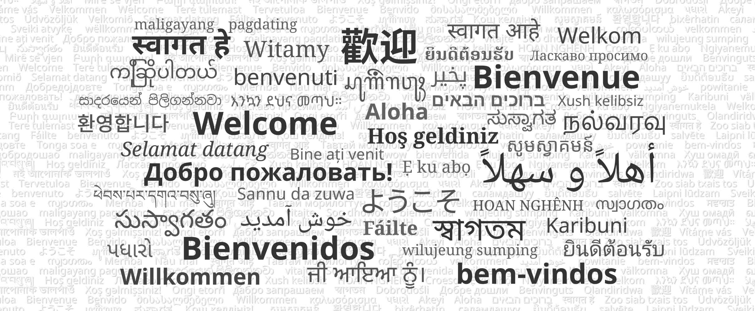 Black and white image showing the phrase 'Welcome' in several languages.